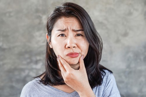 An Asian woman with facial paralysis